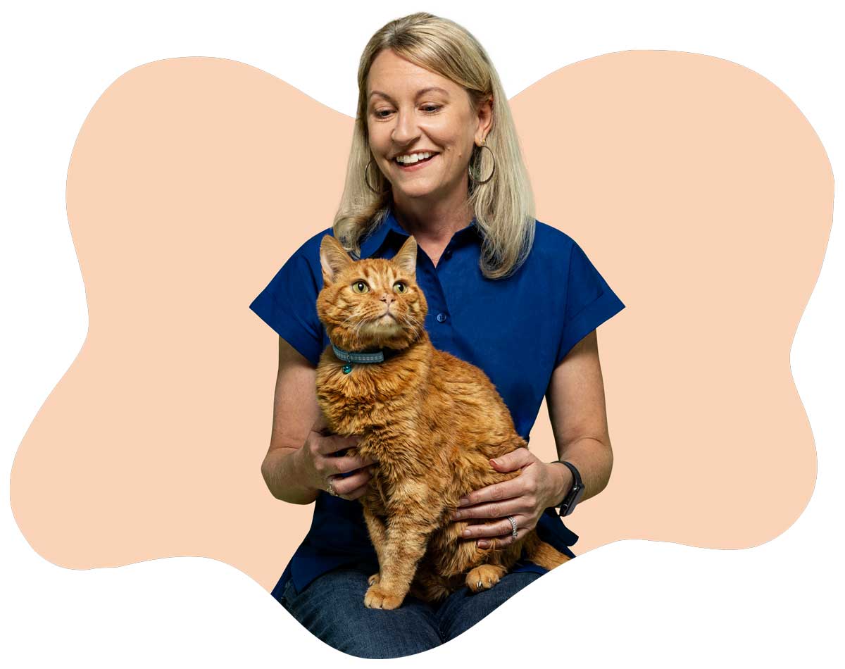 Loralee Stapleton, Marketing Director, holding her orange cat Zeus