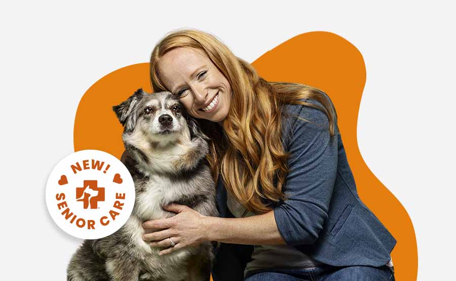 A woman hugging her dog promoting new Banfield Senior Care Optimum Wellness Plans