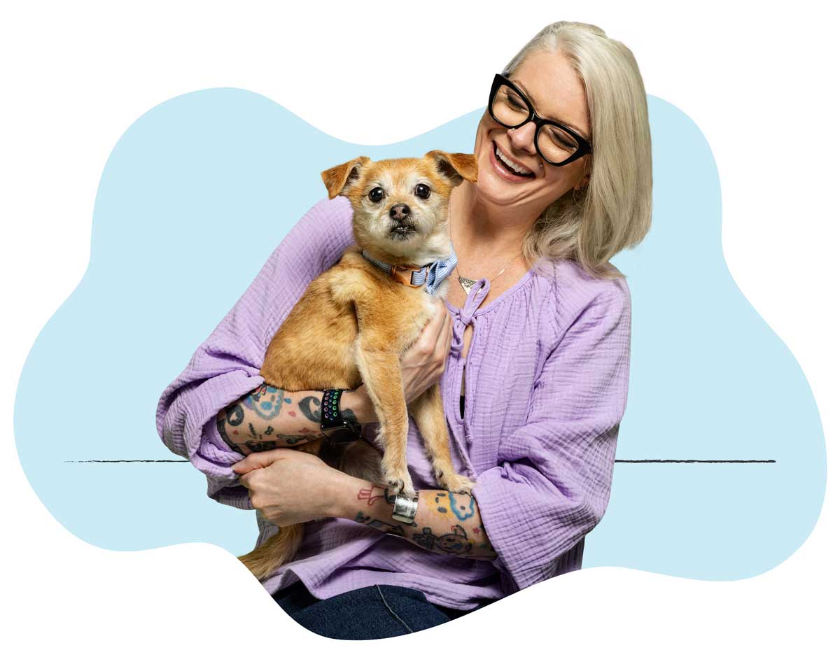 Michelle Slater-Young, Creative Services Director, sitting with her dog in her lap
