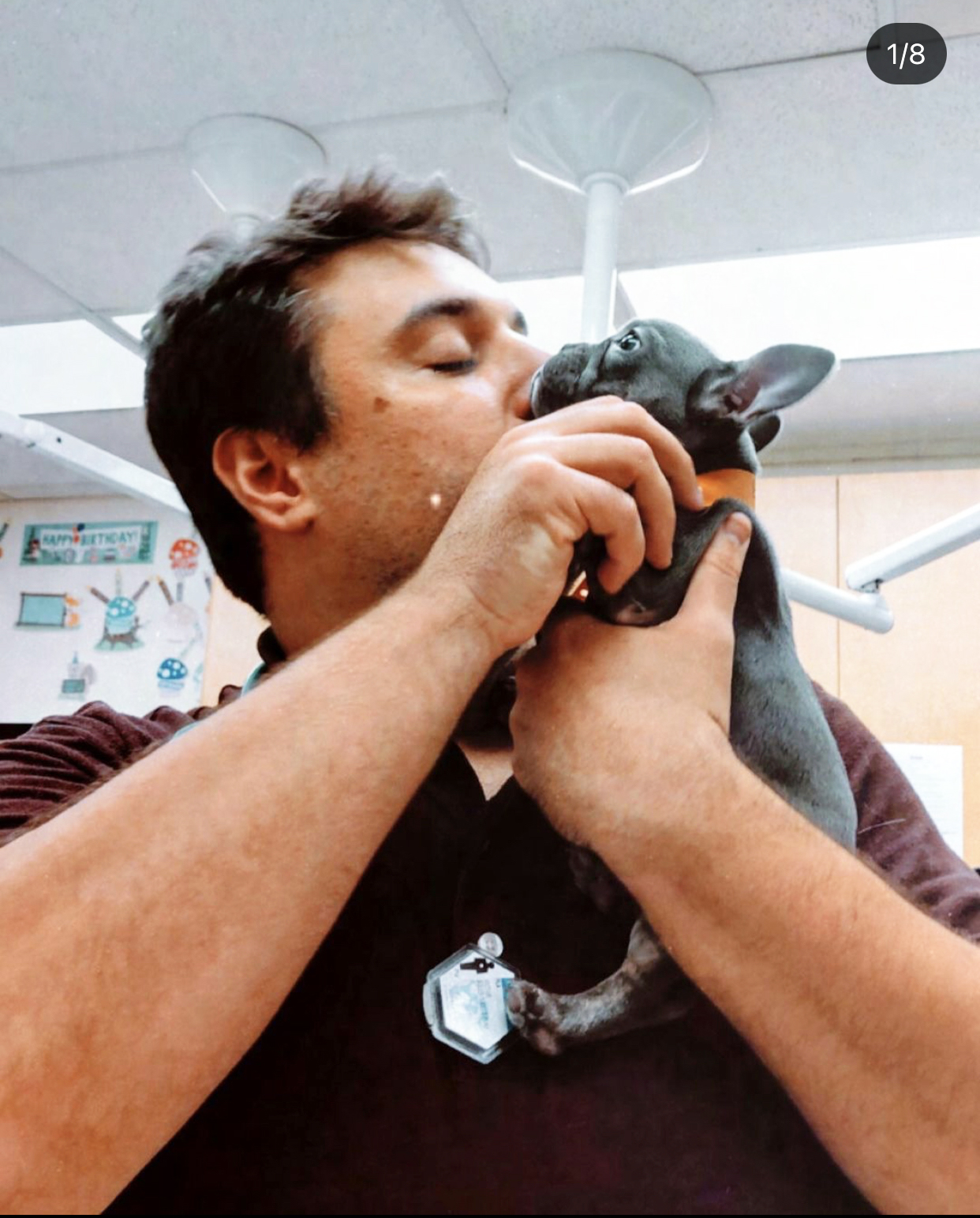 A Banfield staff member hugging and being affectionate to a pet