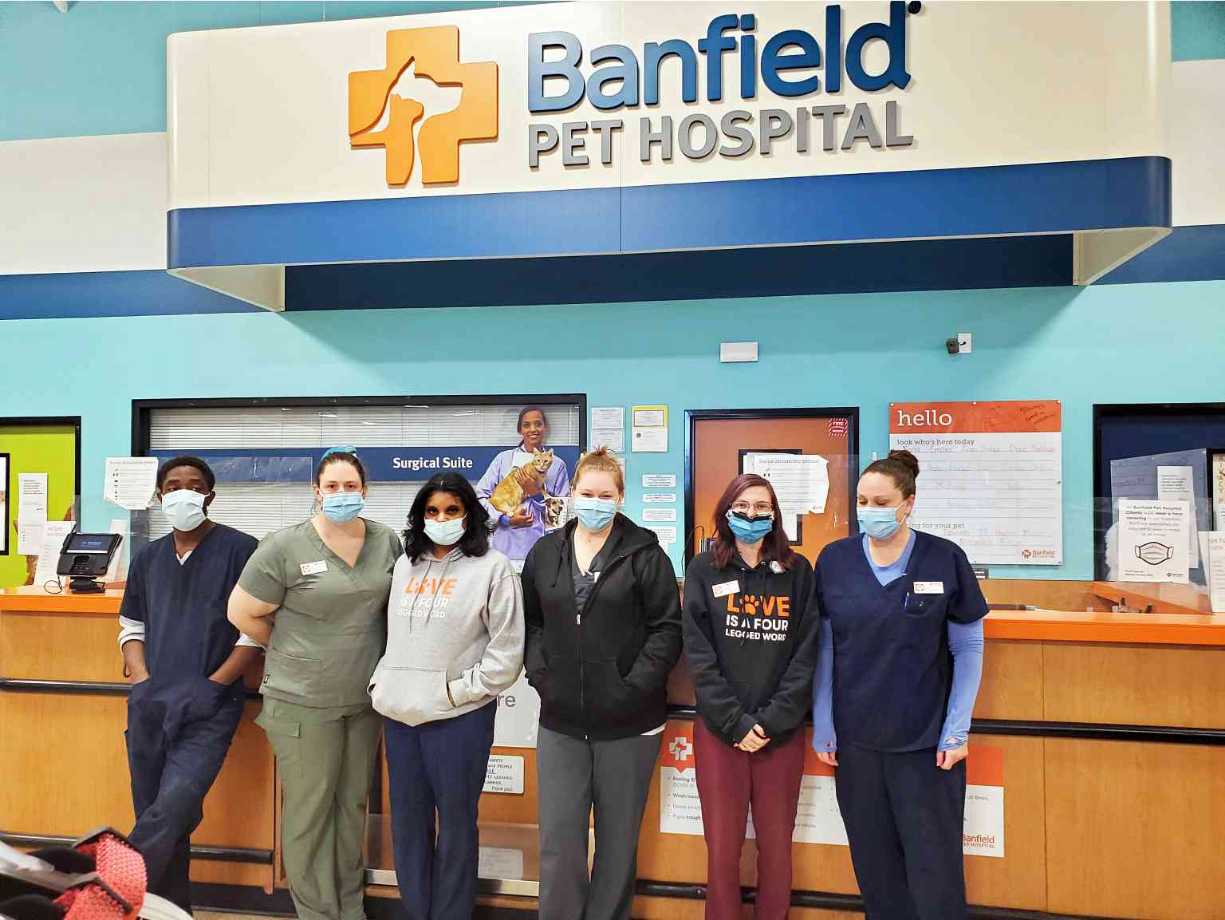 An associate poses with a dog